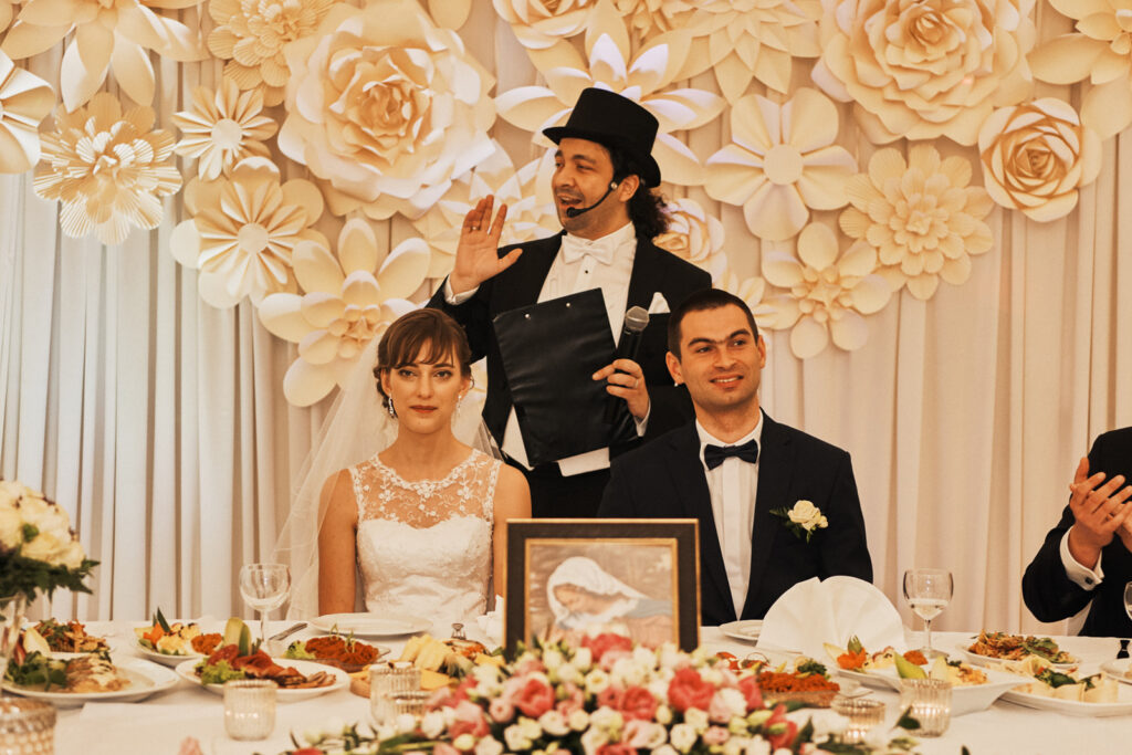 Karol Stolarski at wedding reception with couple